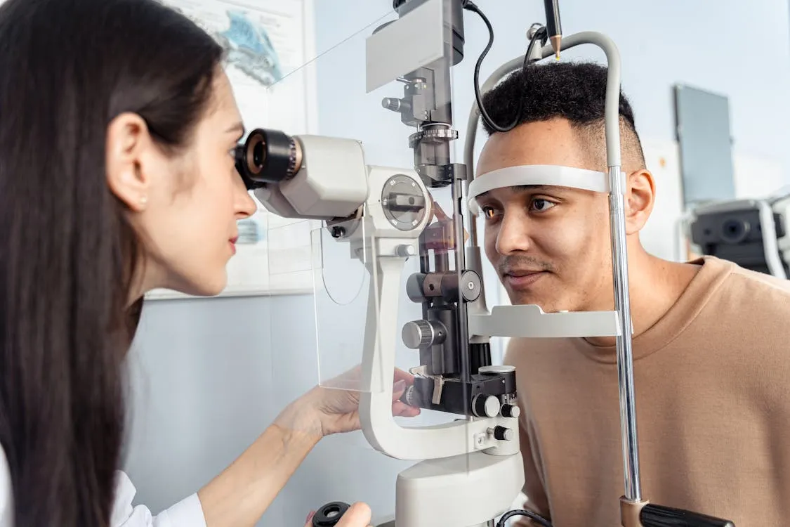 Optometrist conducting a professional eye examination with a patient in a modern optical clinic