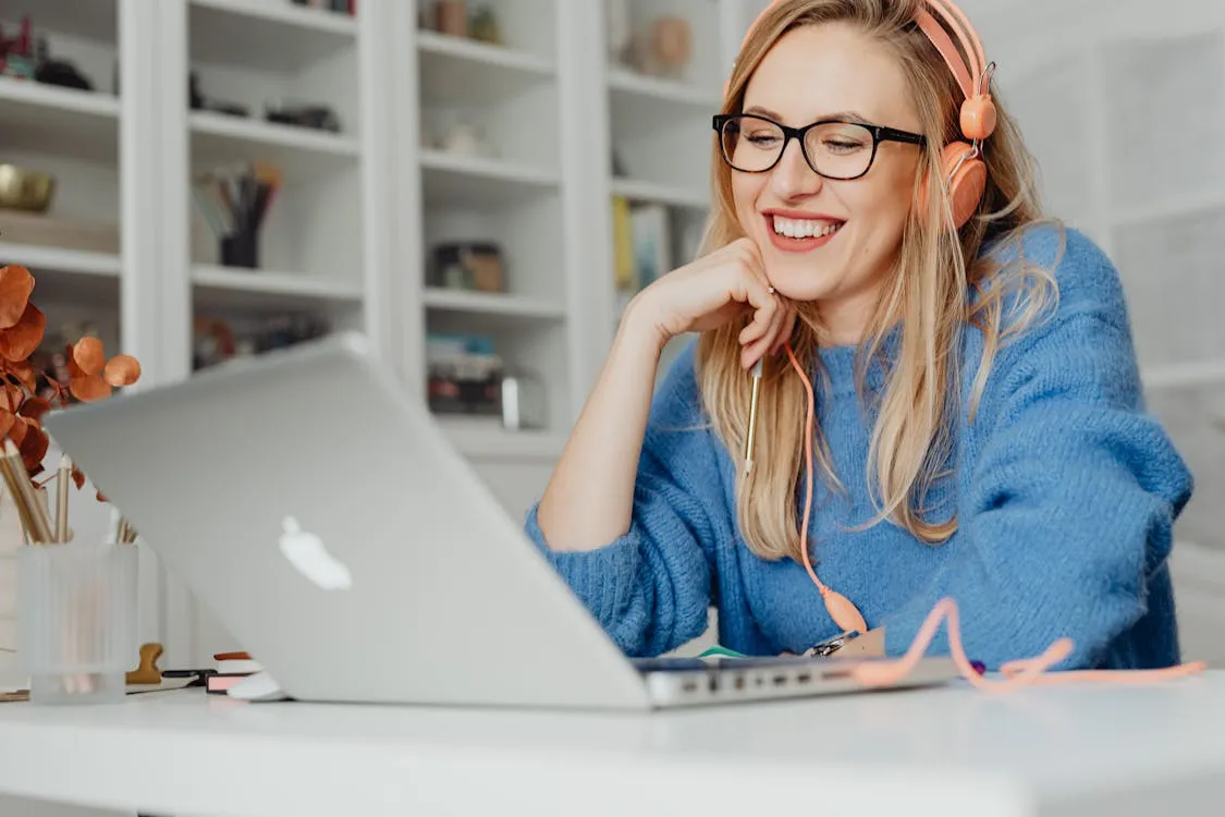 Woman wearing eyeglasses while working on laptop
